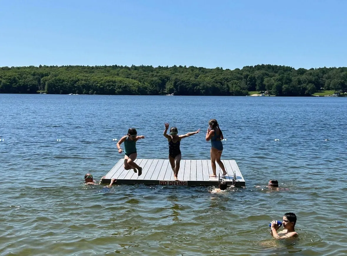Children and families enjoying a summer day at the lake in Coventry, Rhode Island