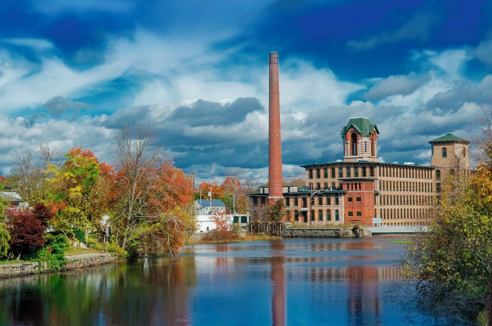 Historic mill beside the water in Coventry, Rhode Island, in autumn